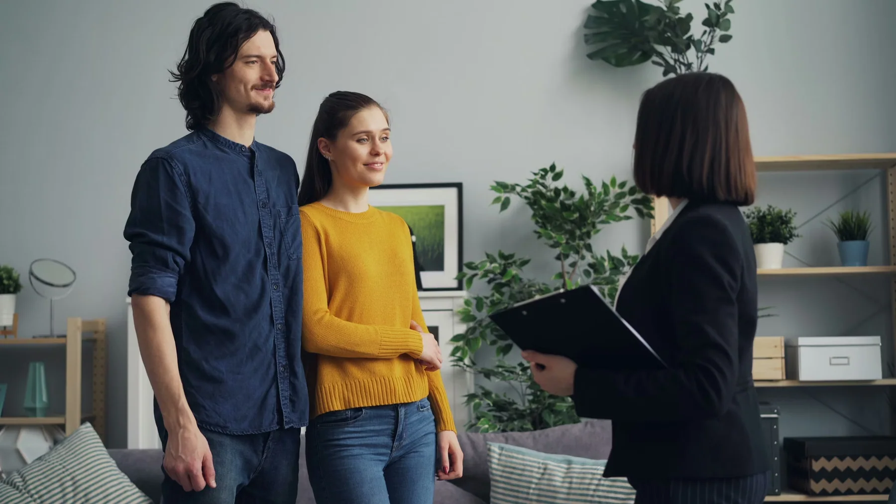 Home buyers speaking with a real estate agent