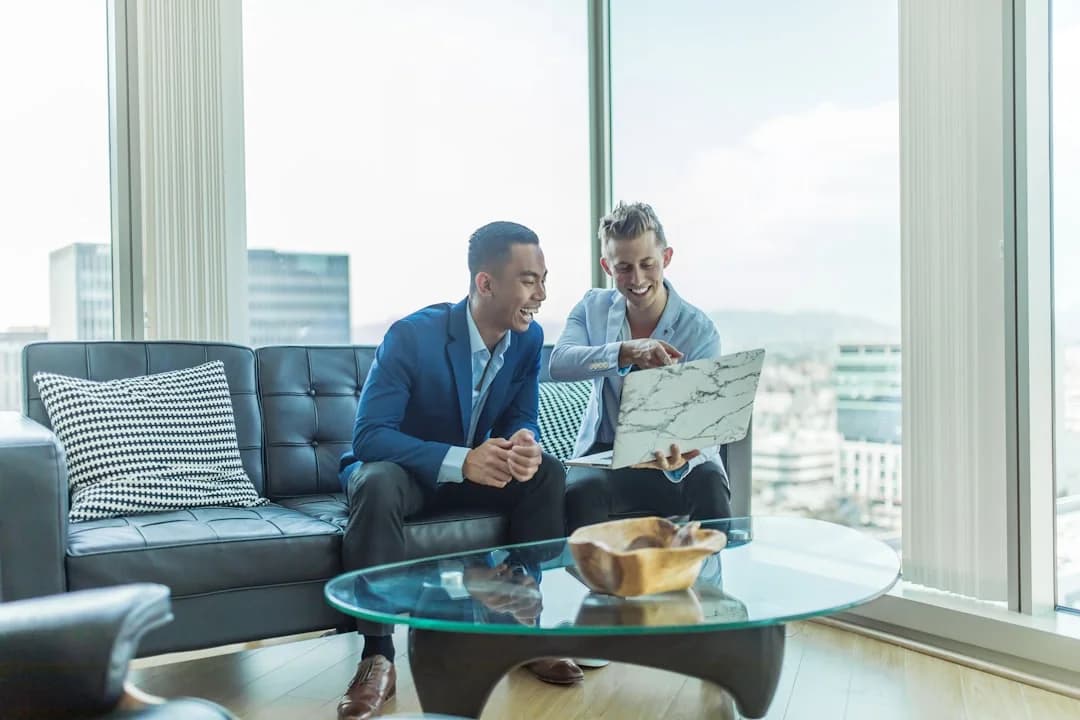 Two people reviewing property information on a laptop